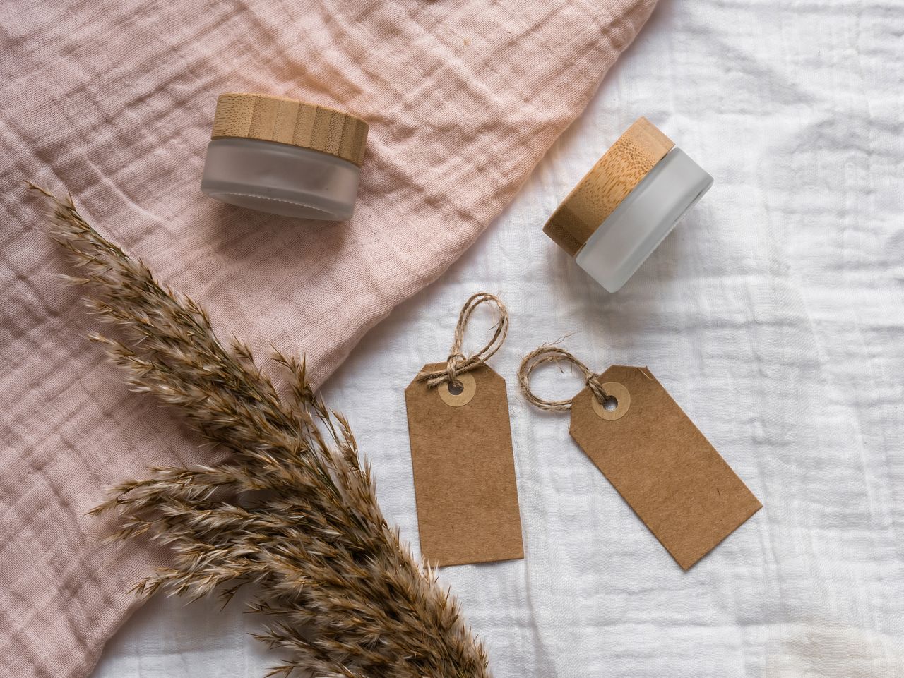 services-01 A rustic flatlay featuring jars with wooden lids and eco-friendly gift tags on textured fabric. Ideal for branding.